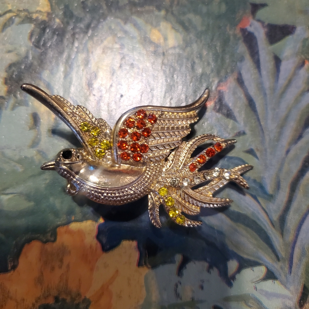 Elegant Silver Bird Brooch with Red and Yellow Accents